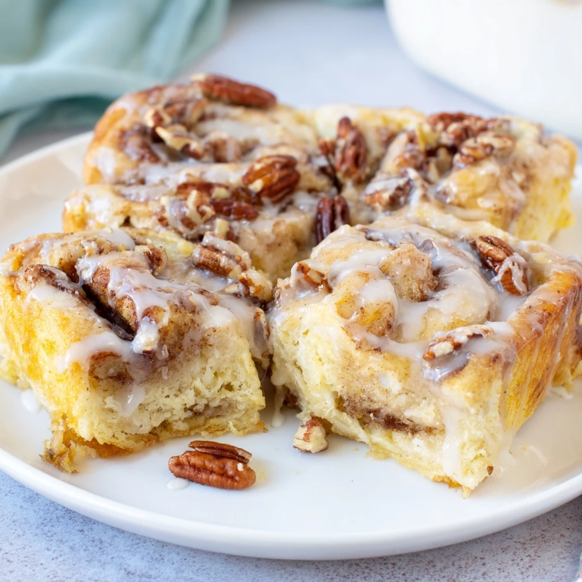 Warm Baked Cinnamon Roll Casserole with creamy custard, glazed and topped with nuts.  