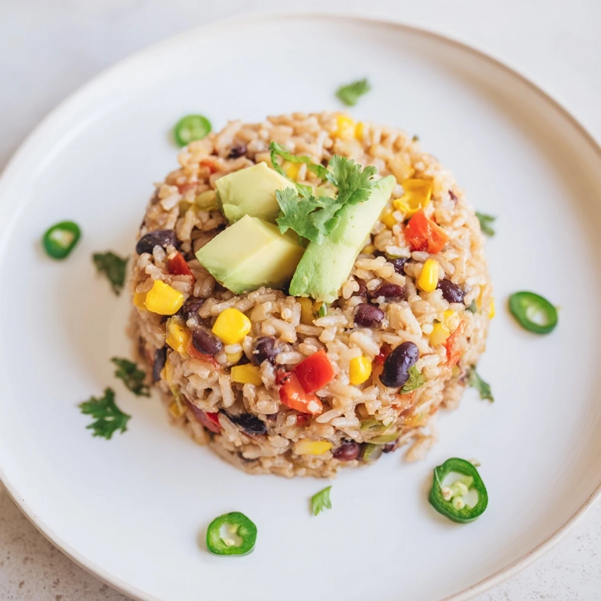 A large skillet filled with delicious one-pot Mexican rice & beans, garnished with fresh cilantro.