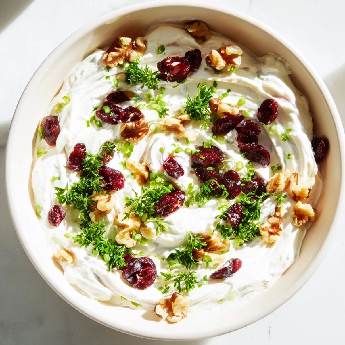 A close-up of the lightened holiday cream cheese dip, showing texture and the colorful toppings on top.