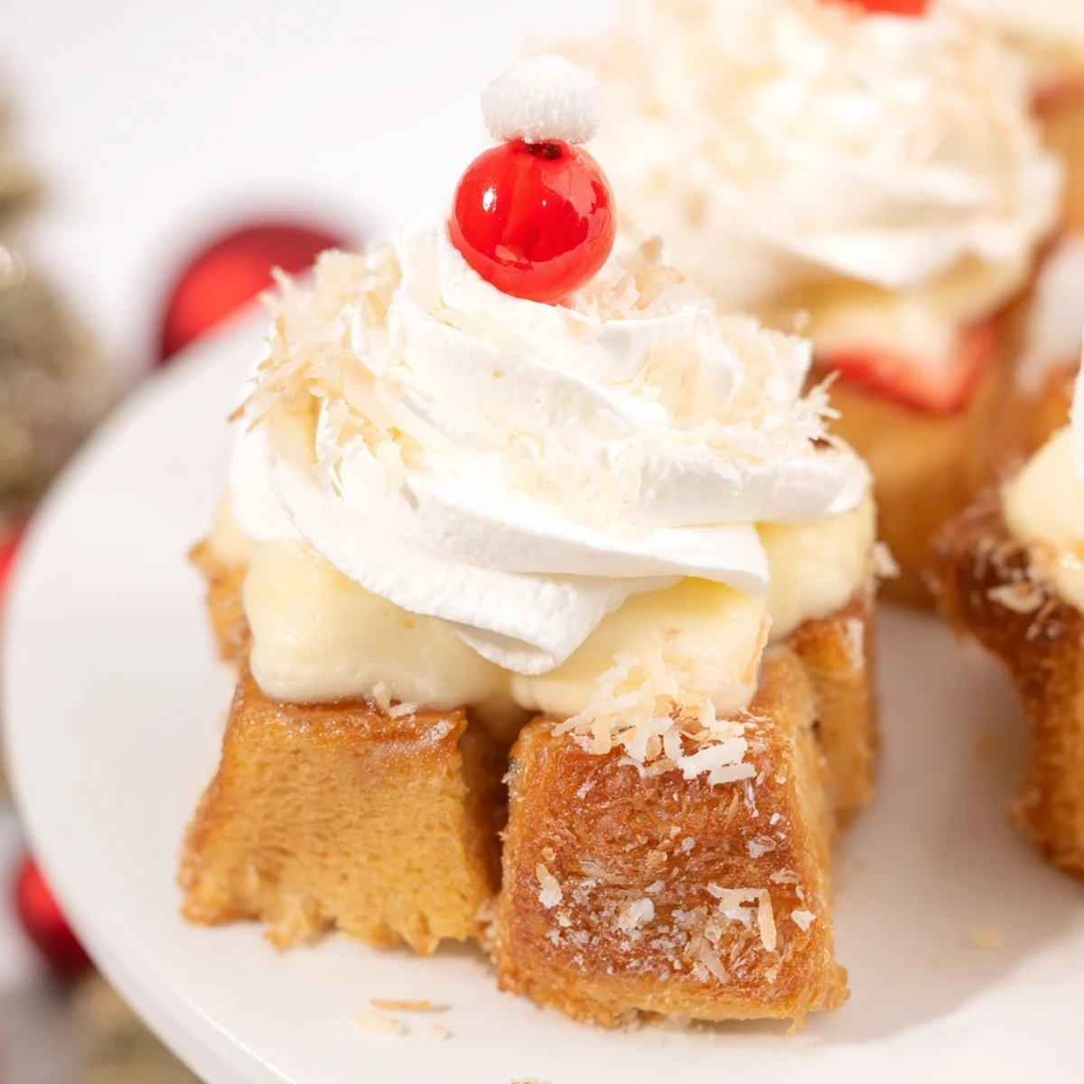 Golden Santa Hat Bread Pudding Bites, wonderfully festive with a creamy whipped topping and a fresh strawberry.
