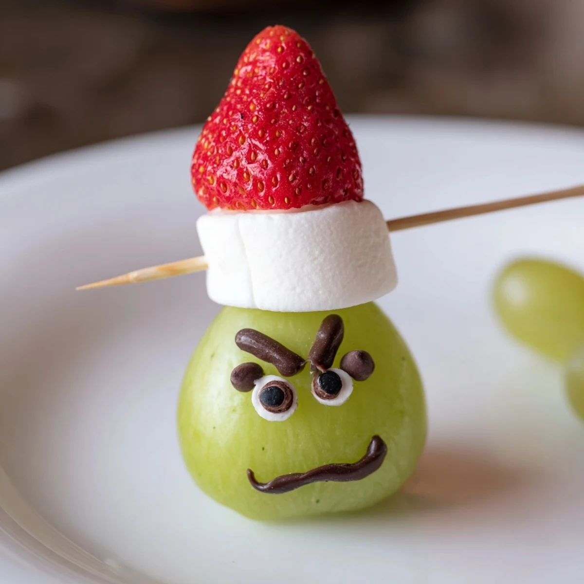 Kid-friendly Grinch Snacks featuring green grapes and sweet marshmallows, perfect for holiday treats.