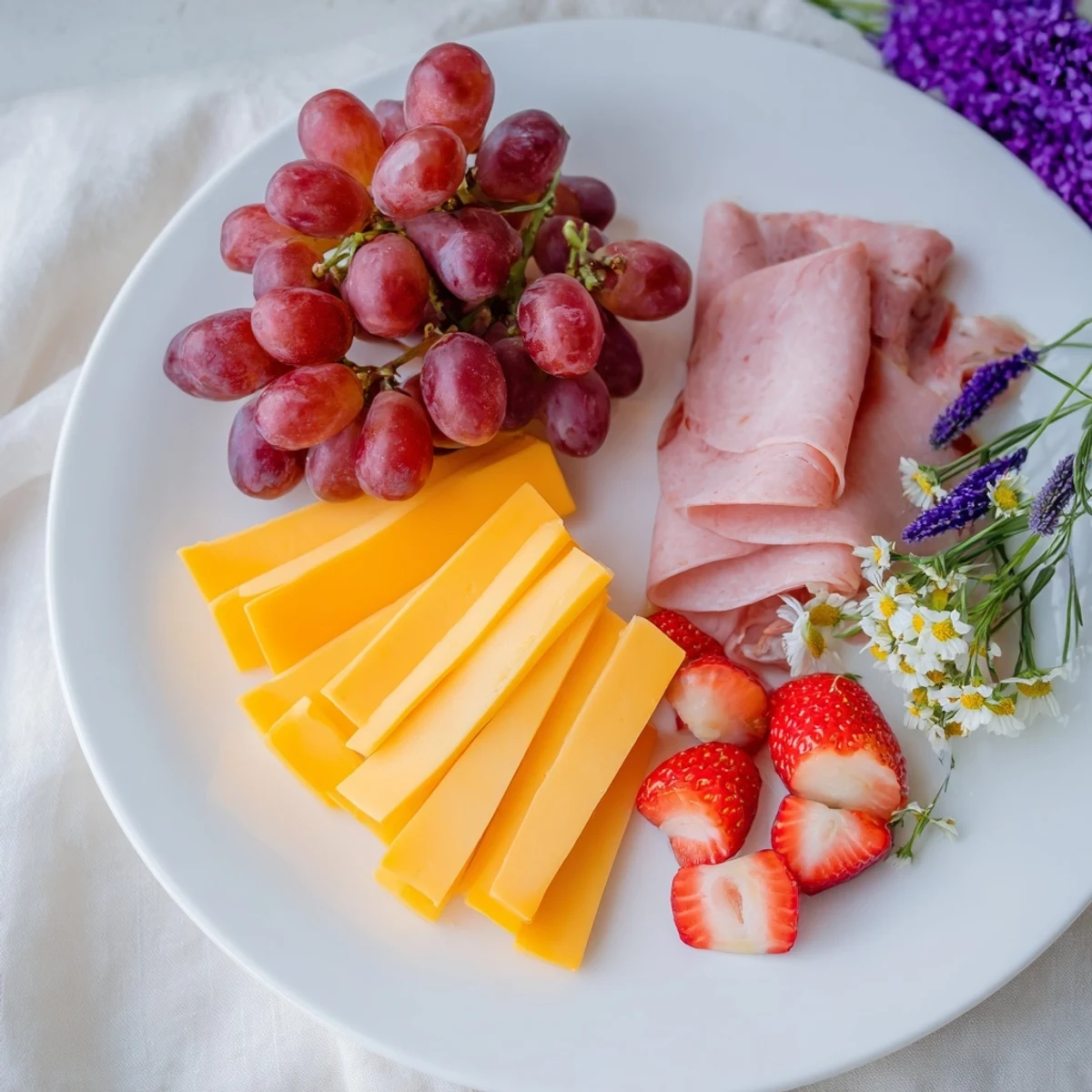 Festive The Nutcracker Suite Board showcases a colorful array of cheeses, charcuterie, and fruits for party guests.