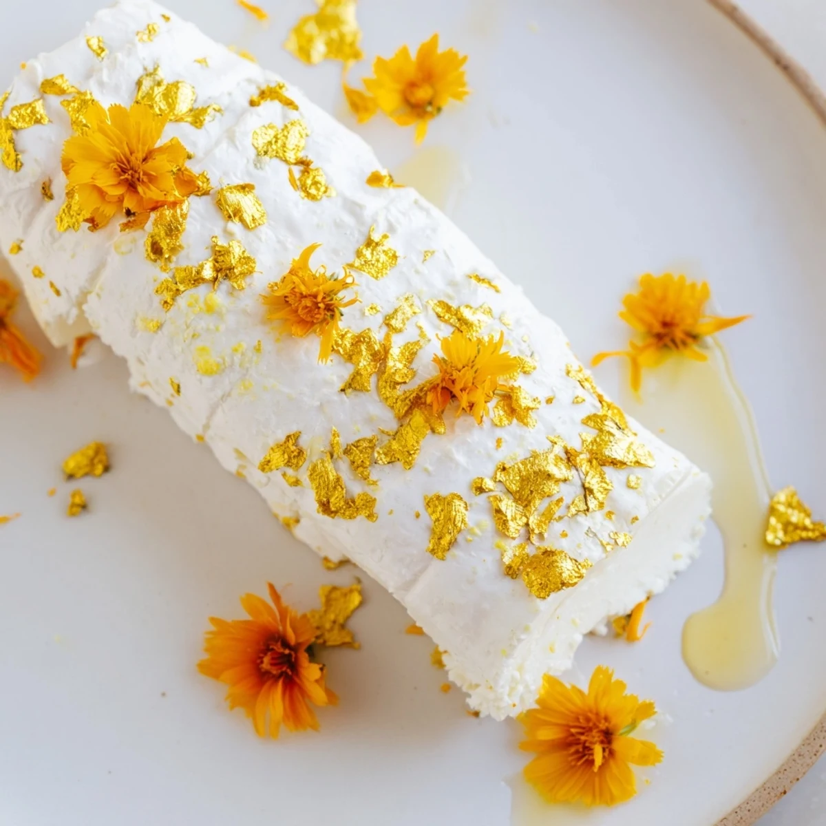 See a close-up of the "Gilded Lily" cheese platter; creamy cheeses sparkle with gold leaf and lovely yellow flowers.