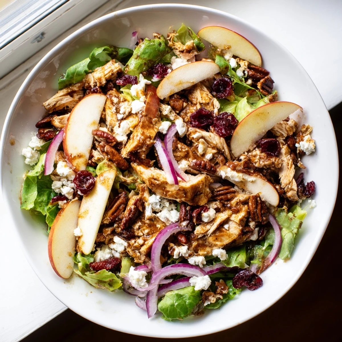 Fresh bowl of Chicken and Apple Winter Salad featuring crisp apples, perfect for a gluten-free meal.