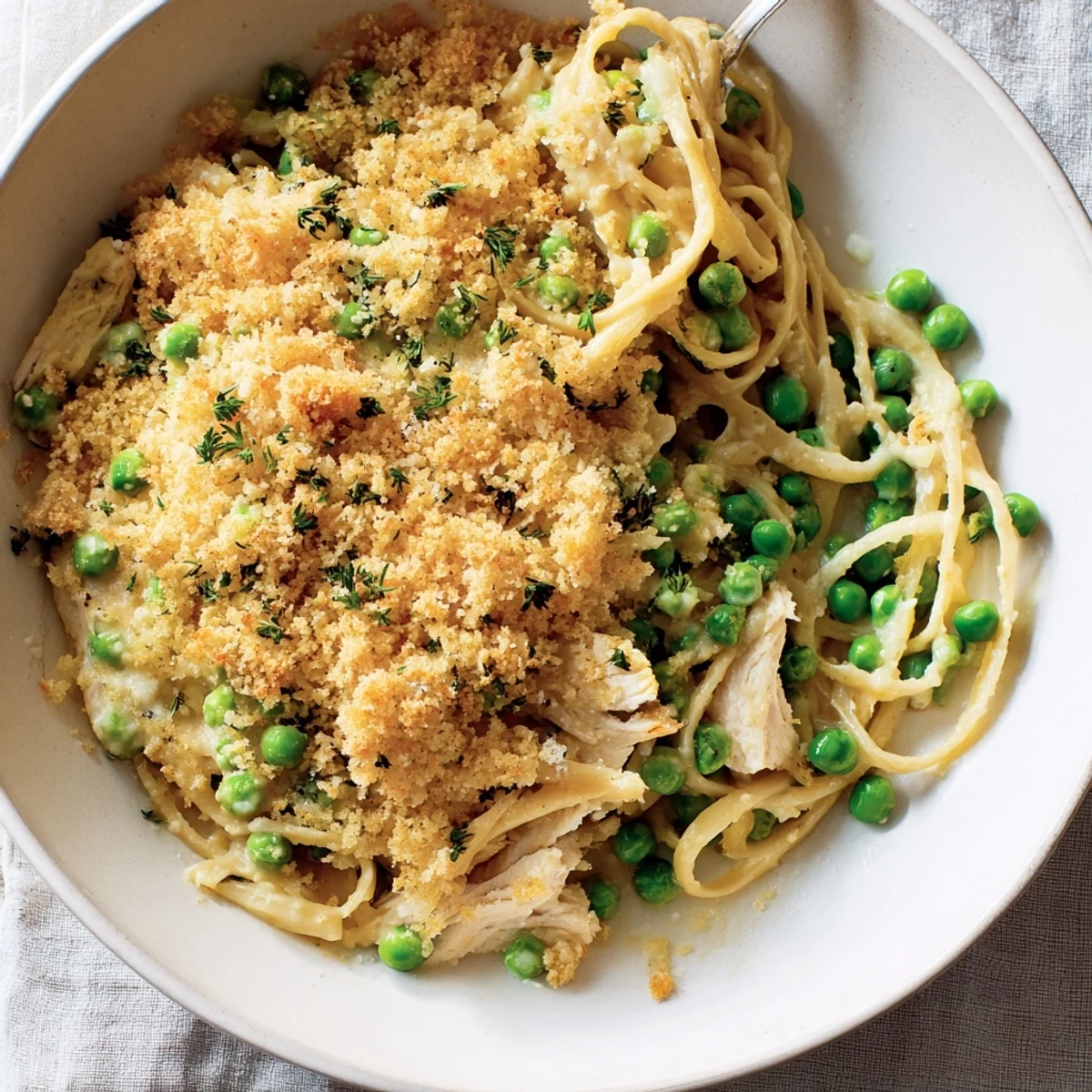 Golden-brown crust on a bubbly Chicken Tetrazzini bake, showcasing tender chicken and creamy pasta.