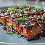 Golden miso-glazed eggplant halves, tender and caramelized, offering a Japanese-inspired vegetarian main or side dish.