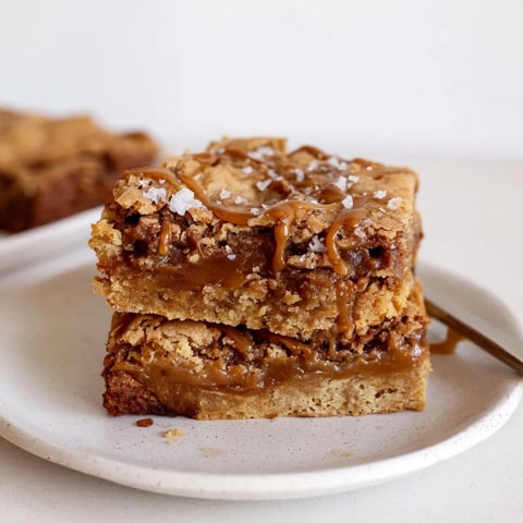 Delicious salted caramel blondie bars drizzled with warm, gooey caramel sauce.  