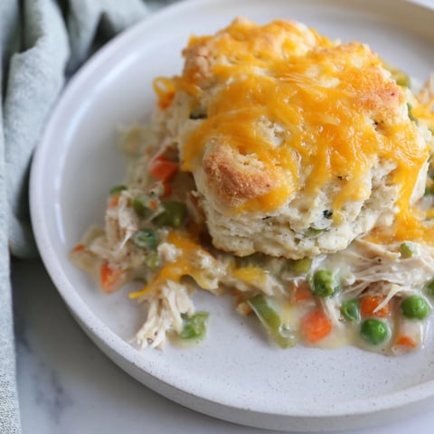 One-Pan Chicken Cobbler, a hot, bubbly casserole topped with golden cheddar biscuits.