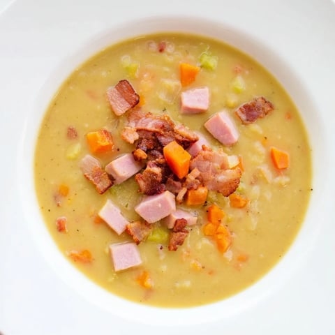 Creamy split pea soup with canned ham and crispy bacon, perfect for a warming lunch.