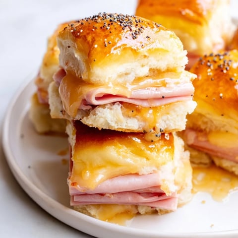 Warm, golden-baked Ham and Cheese Party Sliders with melted Swiss cheese, delicious for sharing.