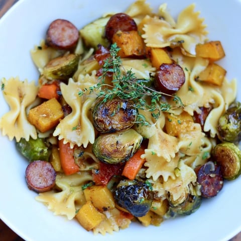 Golden autumn sausage pasta squash with roasted butternut squash and crispy Brussels sprouts.
