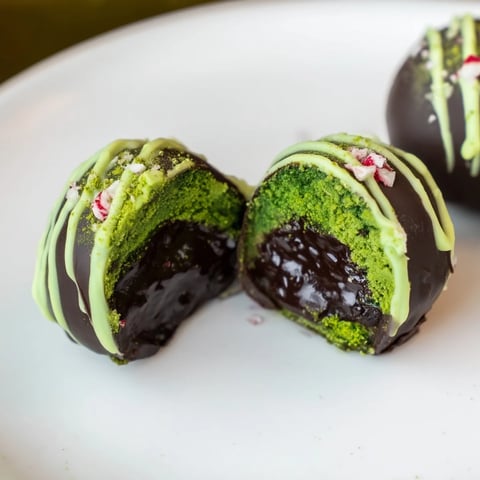 Vibrant green Matcha Dark Chocolate Peppermint Truffles, ready to eat, a beautiful treat with crushed peppermint.