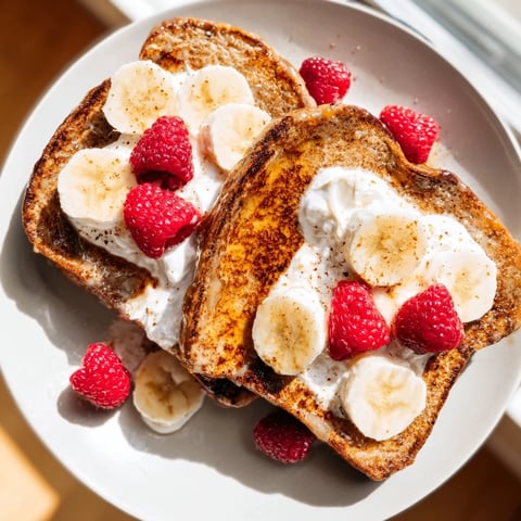 Golden-brown Protein French Toast, topped with fresh berries, promises a delicious, satisfying breakfast.
