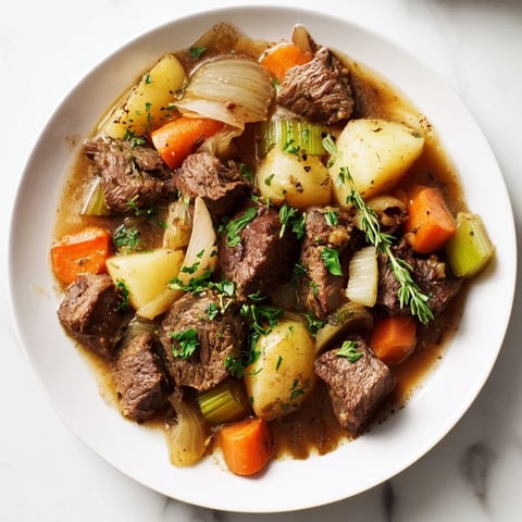 A warm, hearty bowl of Irish Beef Stew with tender beef and vegetables, ready to enjoy.