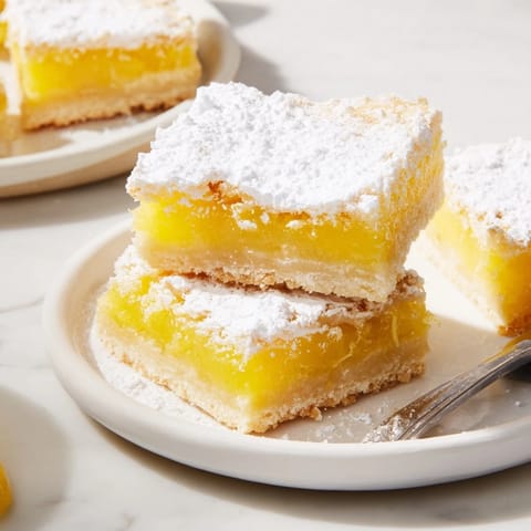 Bright, tangy lemon filling atop a golden shortbread for delightful dessert bites.  