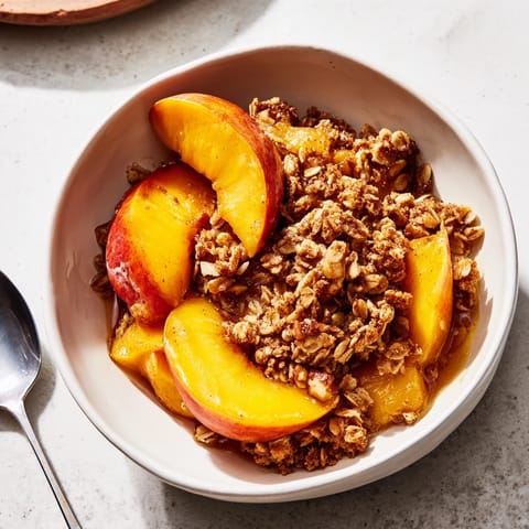 Golden baked peach crisp bursting with honey sweetness and crunchy oat topping.  
