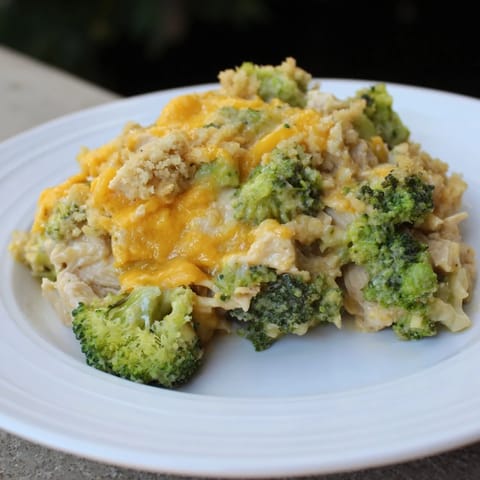 A steaming casserole of flavorful Chicken & Broccoli Cheddar Bake, topped with browned breadcrumbs.