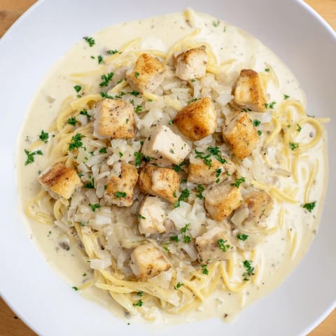 A steaming bowl of One-Pot Cajun Chicken Alfredo Orzo, showcasing the rich, creamy sauce and perfect orzo.