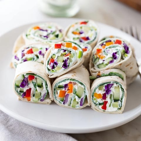 Close-up of Rainbow Veggie Christmas Lights Wrap Pinwheels showing colorful veggie spirals; a perfect appetizer.