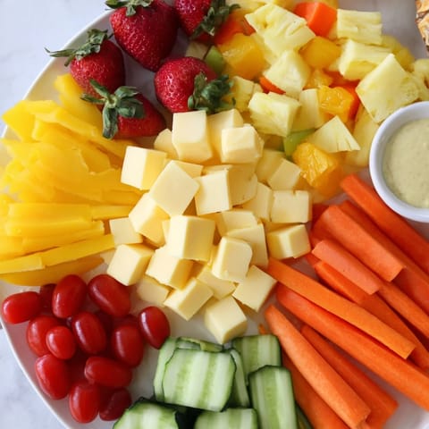 Vibrant Sunshine Snack Tray: A cheerful platter overflowing with colorful fresh fruits, veggies, cheeses, and dips.