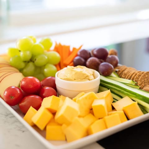 A delicious spread showcasing the Road Trip Snack Platter with assorted crackers, nuts, and fruit.