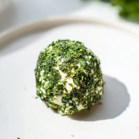 Vibrantly green The Mossy Stone arranged on a serving platter with edible flowers, ready to eat.