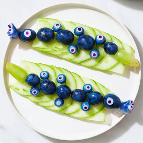 Prepare a visually charming Peacock Tail with cucumber, grapes, and radish accents; perfect for any gathering.