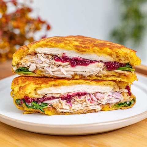 Golden-brown Moist Maker Chicken Wrap, ready to eat, featuring layers of chicken, stuffing, and cranberry sauce.