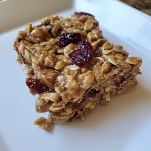 Delicious, homemade maple cinnamon oatmeal bars, showing the hearty texture of a baked sweet snack.