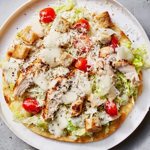 Savory Chicken Caesar Flatbread, perfectly baked with melted cheese, fresh toppings, and grilled chicken.