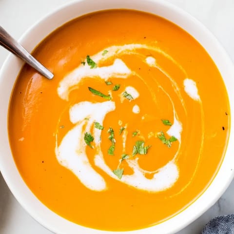 Smooth and zesty Carrot Ginger Soup, perfect for a healthy lunch with a lemon kick.
