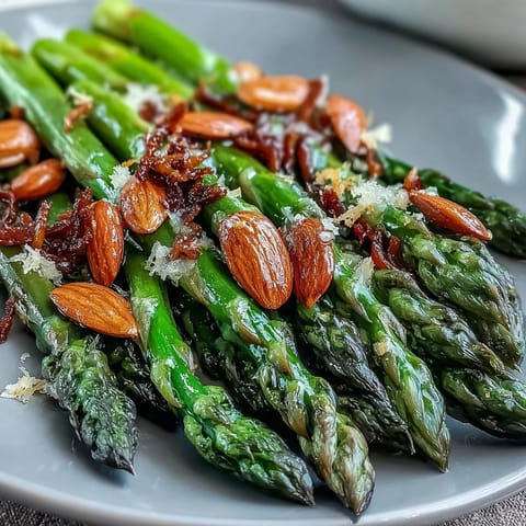 Fresh asparagus sautéed in butter with lemon zest and toasted almonds for a vibrant spring side dish.
