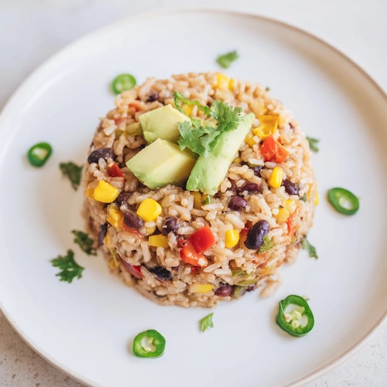 A large skillet filled with delicious one-pot Mexican rice & beans, garnished with fresh cilantro.