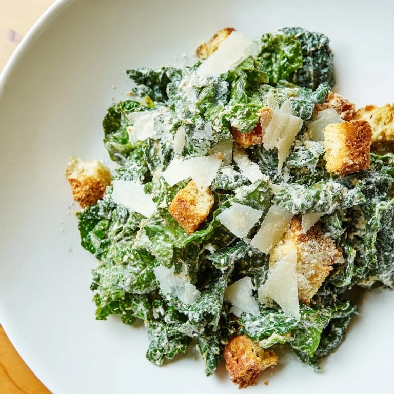 Creamy homemade Kale Caesar Salad recipe, featuring massaged kale and finished with golden croutons.