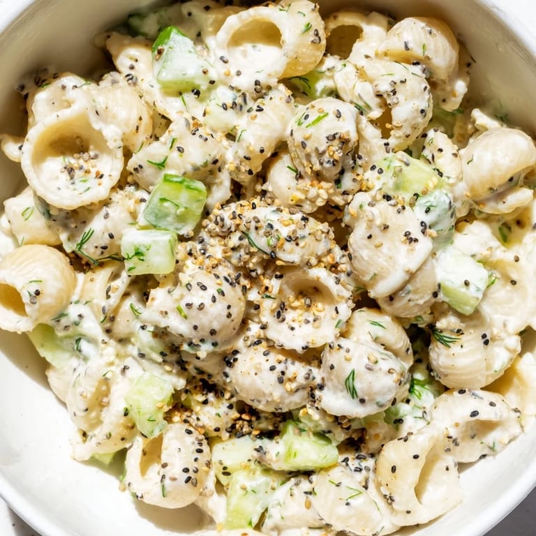A chilled, creamy pasta salad topped with everything bagel seasoning, perfect for summer picnics and BBQs.