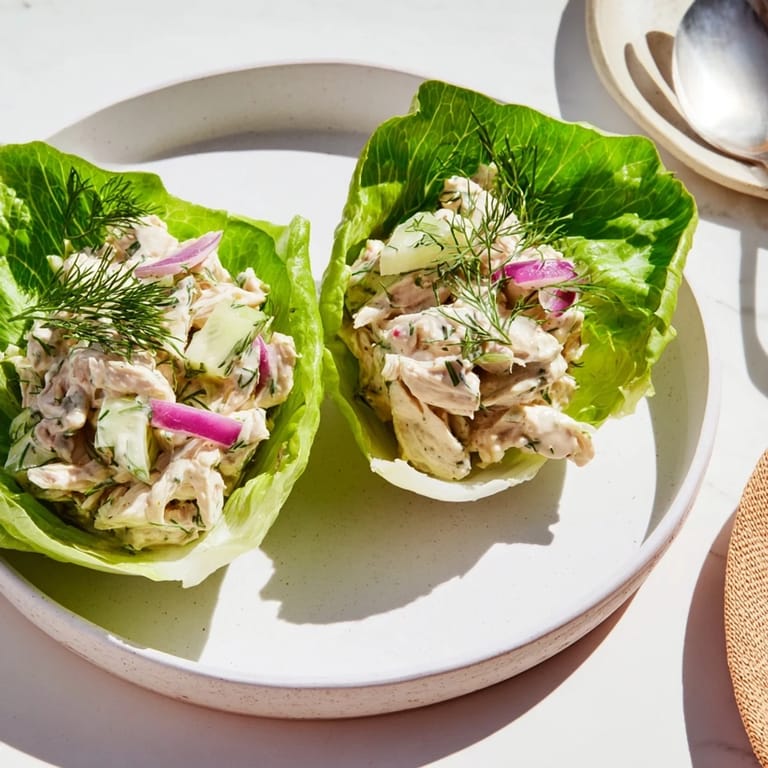 Freshly chopped dill pickles and tender shredded chicken mingle in a creamy dressing, served in cool lettuce cups.