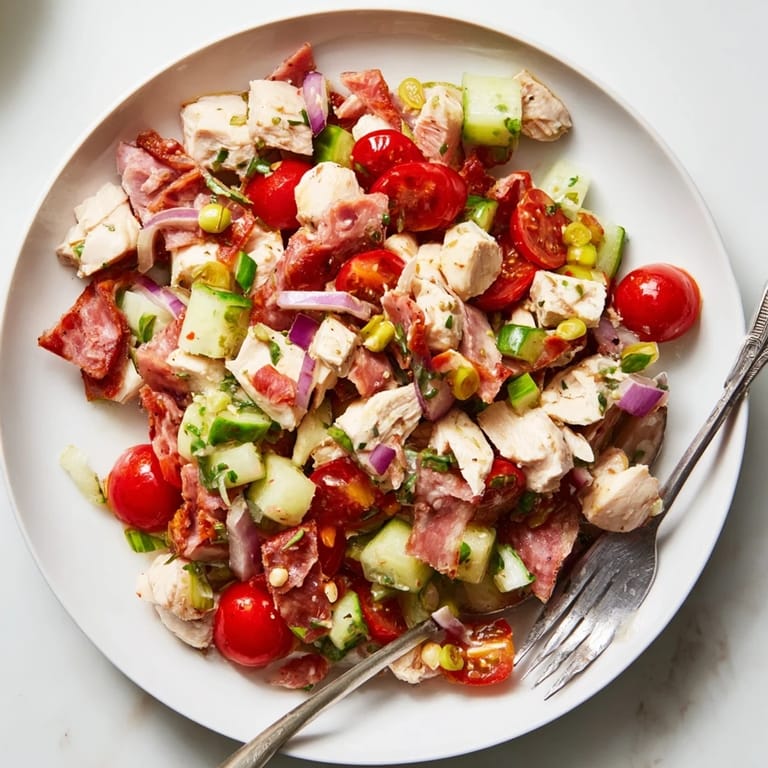 Freshly prepared Italian Deli Chopped Chicken Salad features a colorful medley of chopped vegetables, savory meats, and cheese, perfect for a quick and hearty meal.