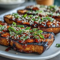Silky roasted eggplant glazed with sweet-savory miso, caramelized to golden perfection for an umami-rich vegetarian dish.